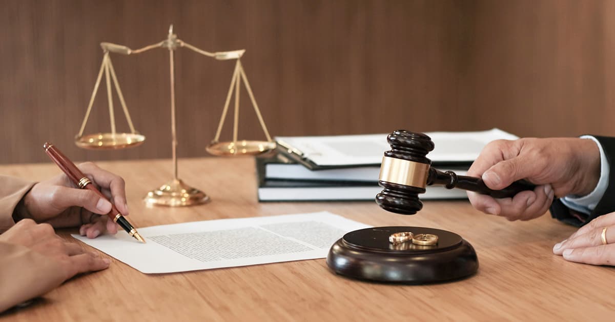Divorce legal documents with gavel, rings, and scales of justice