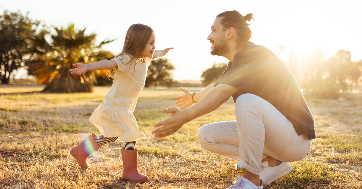father daughter outside in summer time