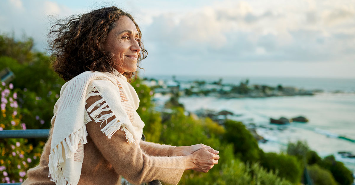 happy woman looking out at the ocean