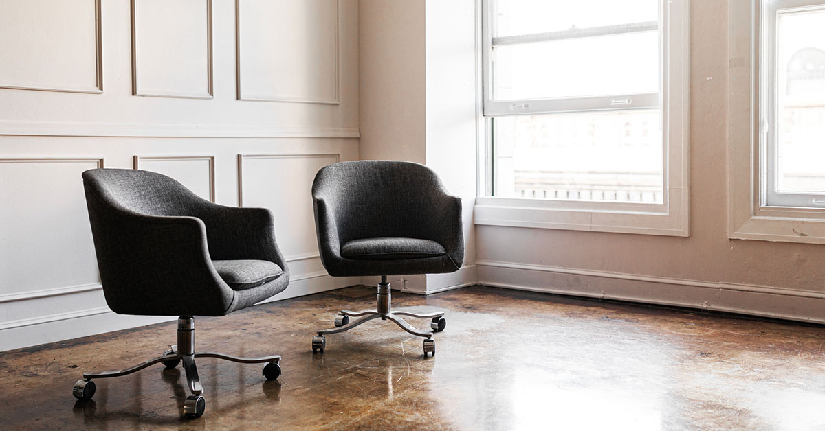 two empty chairs ready for a mediation meeting